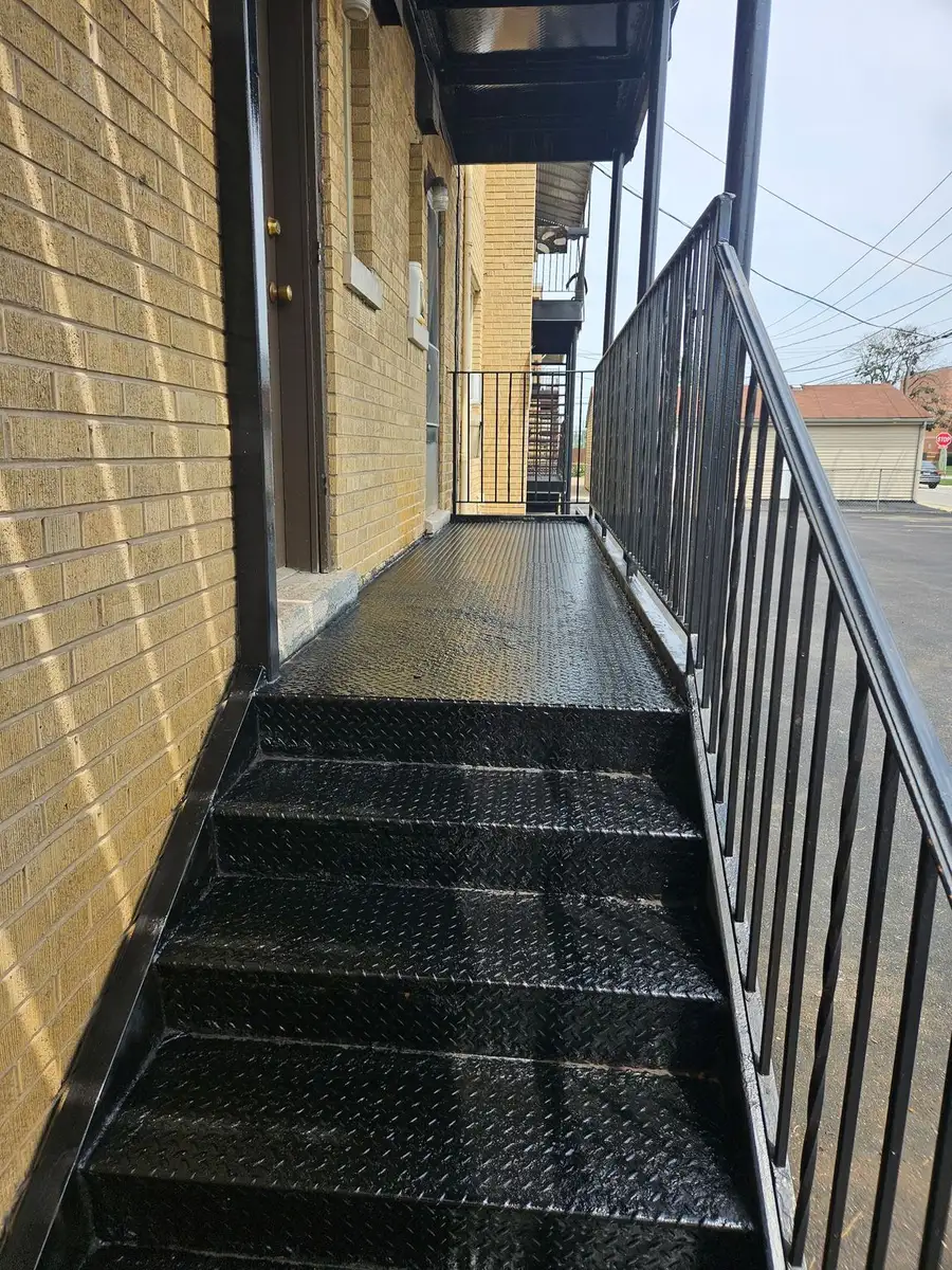 Repaired exterior metal staircase with steel railing